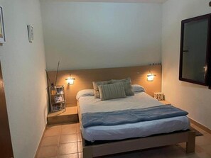 Cozy retreat with a single bed, nightstands, and a large mirror.