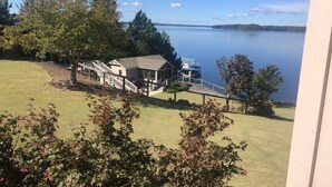 A lakeside property with a house, a dock, and a grassy area. - Amazing lake view and sunsets! Perfect for Masters hosting 2024!

 (Modoc)