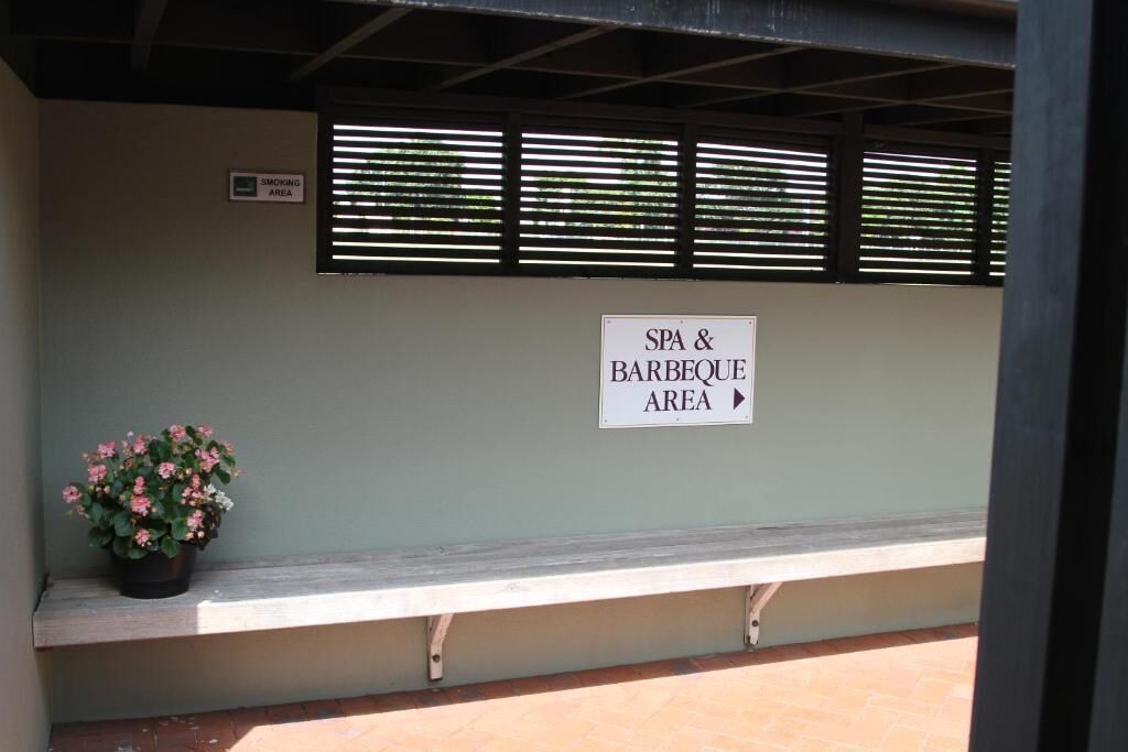 A sign indicating a smoking area and a spa & barbecue area.