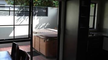 A modern kitchen with a sliding glass door leading to a patio area.