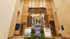A lobby with a chandelier, a reception desk, and informational displays. - Shijiazhuang Nuohuating Hotel (Shijiazhuang)