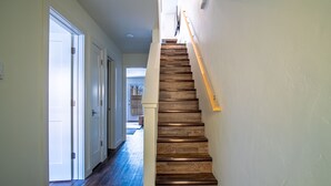 A wooden staircase with a handrail, leading to an upper floor. - Steps to Free Shuttle • 3-Min Ride to Ski Lifts & Ketchum (Ketchum)