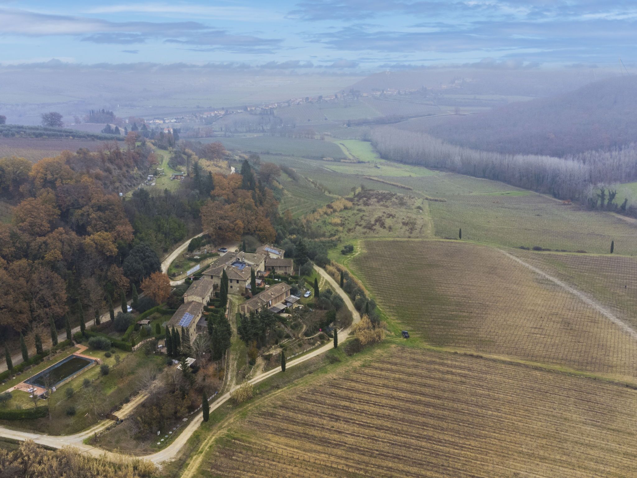 An aerial view of a rural area with fields, a small village, and a church.