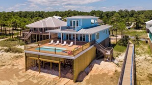 A beachfront house with a pool, deck, and multiple levels. - Coastal Charm | Nightly stays starting 9/20! Pool (Dauphin Island)