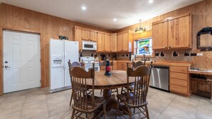 A kitchen with wooden cabinets, a white refrigerator, a stove, and a dishwasher.