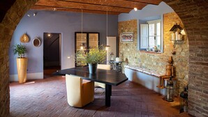 A dining area with a central table, stone walls, and rustic wooden beams. - Beautiful private villa for 11 people with WIFI, A/C, private pool, TV, patio and panoramic view (Bobolino)