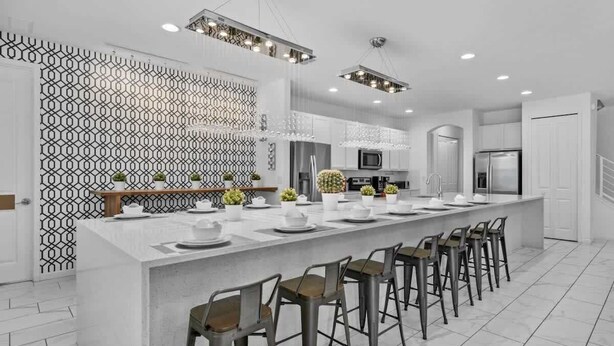 A modern kitchen with a central island, bar stools, and pendant lighting. - 15BD Sonoma Resort Luxury House  (SR2609) (Kissimmee)