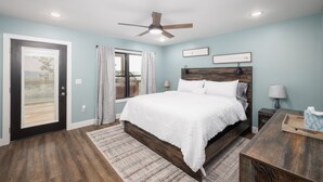 A bedroom with a bed, a ceiling fan, a nightstand, a lamp, and a window with curtains. - Cozy Cabin In The Sky, with direct access to public hunting, fishing access. (Dixon)