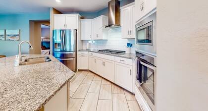 Single-story home with enclosed yard, private pool, hot tub, patio, & grill