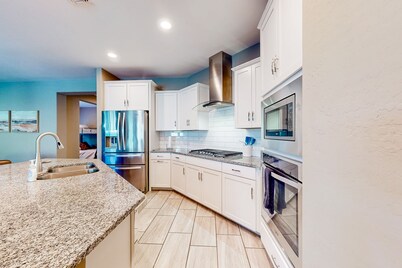 Single-story home with enclosed yard, private pool, hot tub, patio, & grill