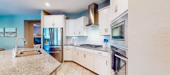 Single-story home with enclosed yard, private pool, hot tub, patio, & grill