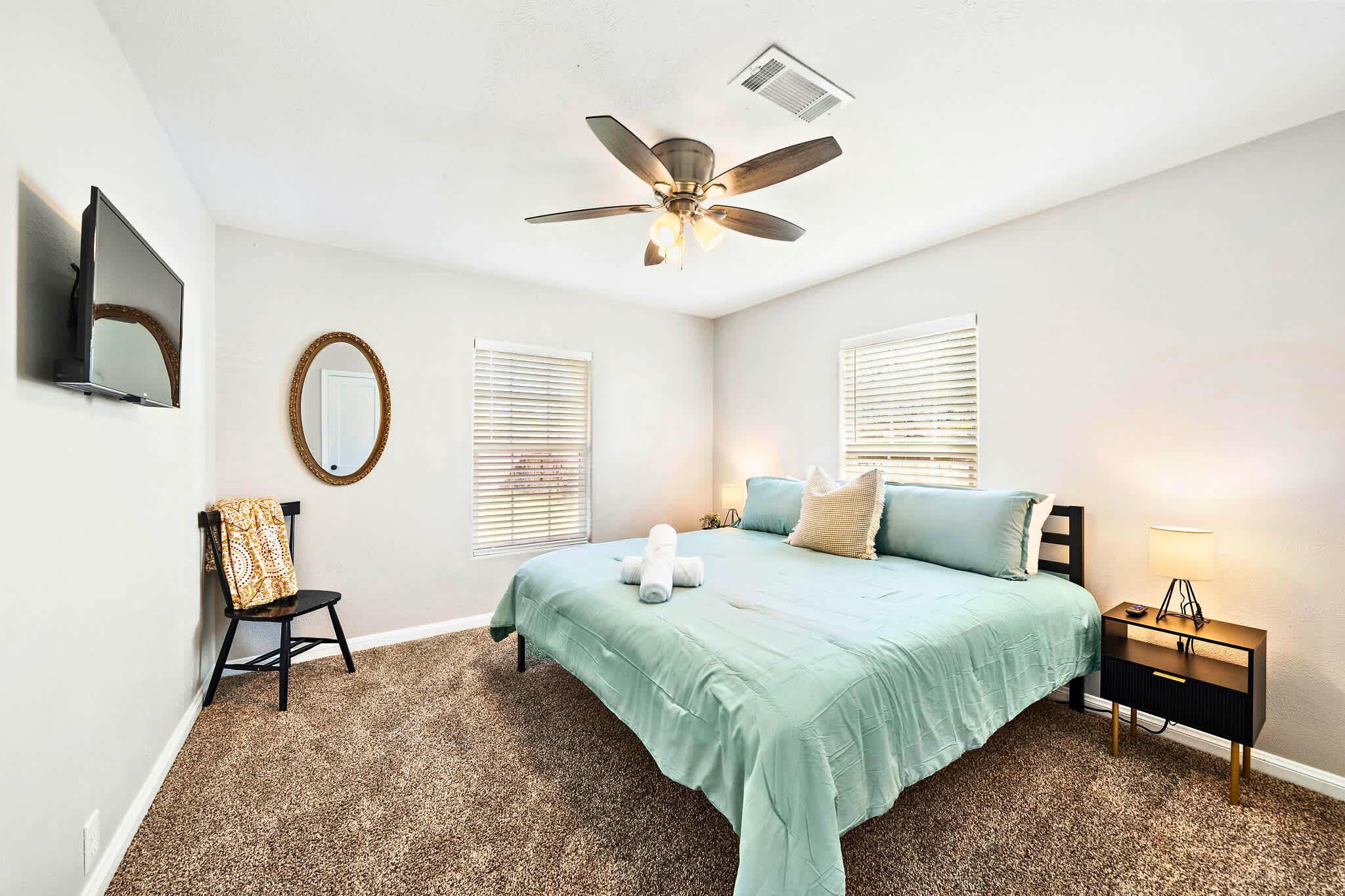 Bedroom Retreat: Spacious room with plush carpet, modern decor, and bright sunlight streaming in!