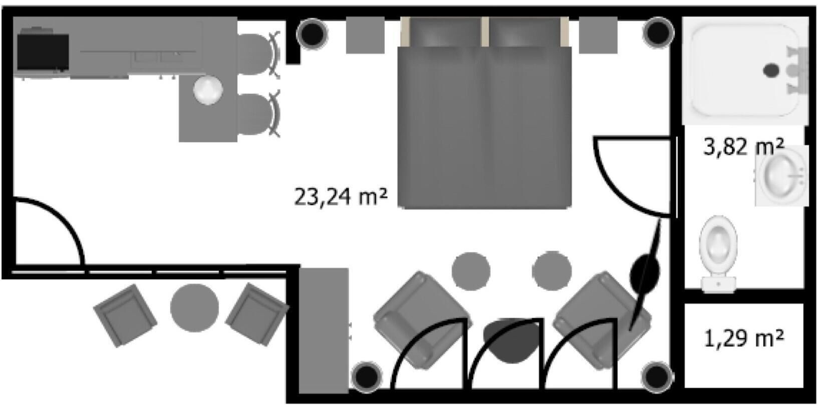 A hotel room layout with a bed, a bathroom, and a dining area.