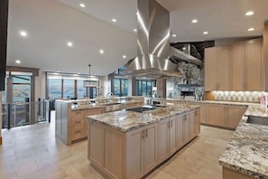 A spacious kitchen with granite countertops, stainless steel appliances, and a large island.