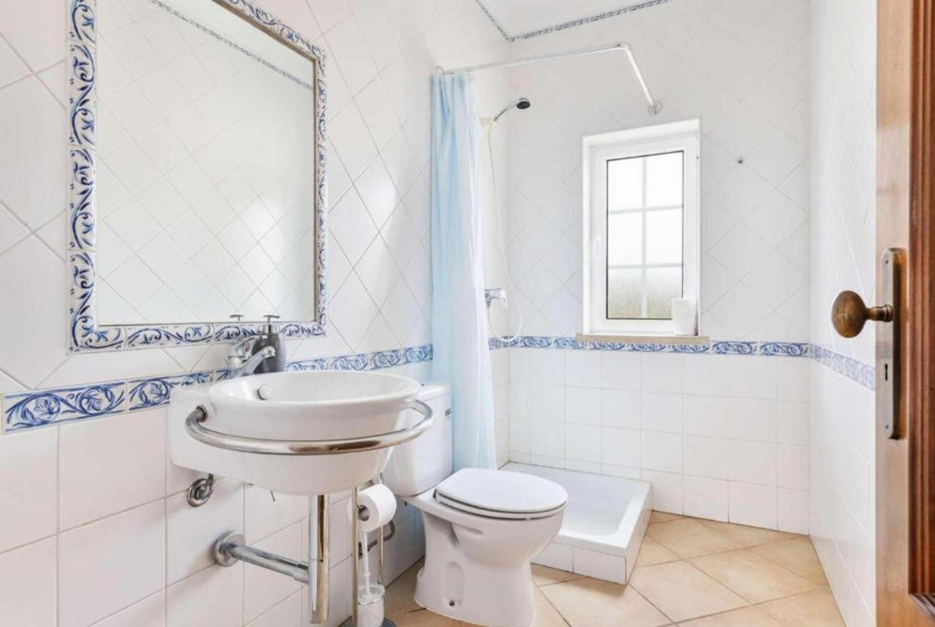 A bathroom with a sink, toilet, and shower.