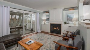A living room with a fireplace, a sofa, a coffee table, and a fireplace mantel. - On The Rocks! Spacious family-friendly 4BR home w/ bonus room (Basye)