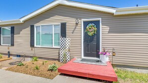 A single-story house with a front porch, a mailbox, and a small garden area. - Modern Bloomington Home ~ 10 Mi to Bear Lake! (Bloomington)