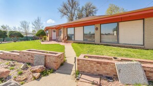 A two-story building with a red roof, large windows, and a brick exterior. - 5 Mi to Dtwn Denver: Pet-Friendly Home w/ Patio (Denver)
