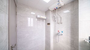 A modern bathroom with a shower, a towel rack, and a hand dryer. - Moon Hotel Apartment Guangzhou Baijiang (Guangzhou)