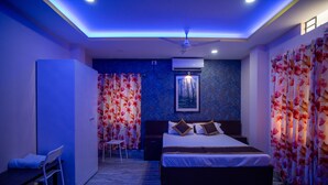 A modern hotel room with a large bed, a desk, and a chair. - Siliguri Club (Jalpaiguri)