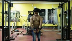A gym with various exercise equipment, including a cable machine and weight benches. - Siliguri Club (Jalpaiguri)