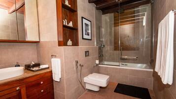 A modern bathroom with a shower, toilet, and sink.