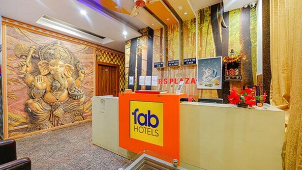 A reception area with a 'fab hotels' sign, a large mural, and a 'RSPLAZA' sign. - FabHotel Shanti Stay (New Delhi)