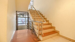 A staircase with metal railings and a glass door at the top.