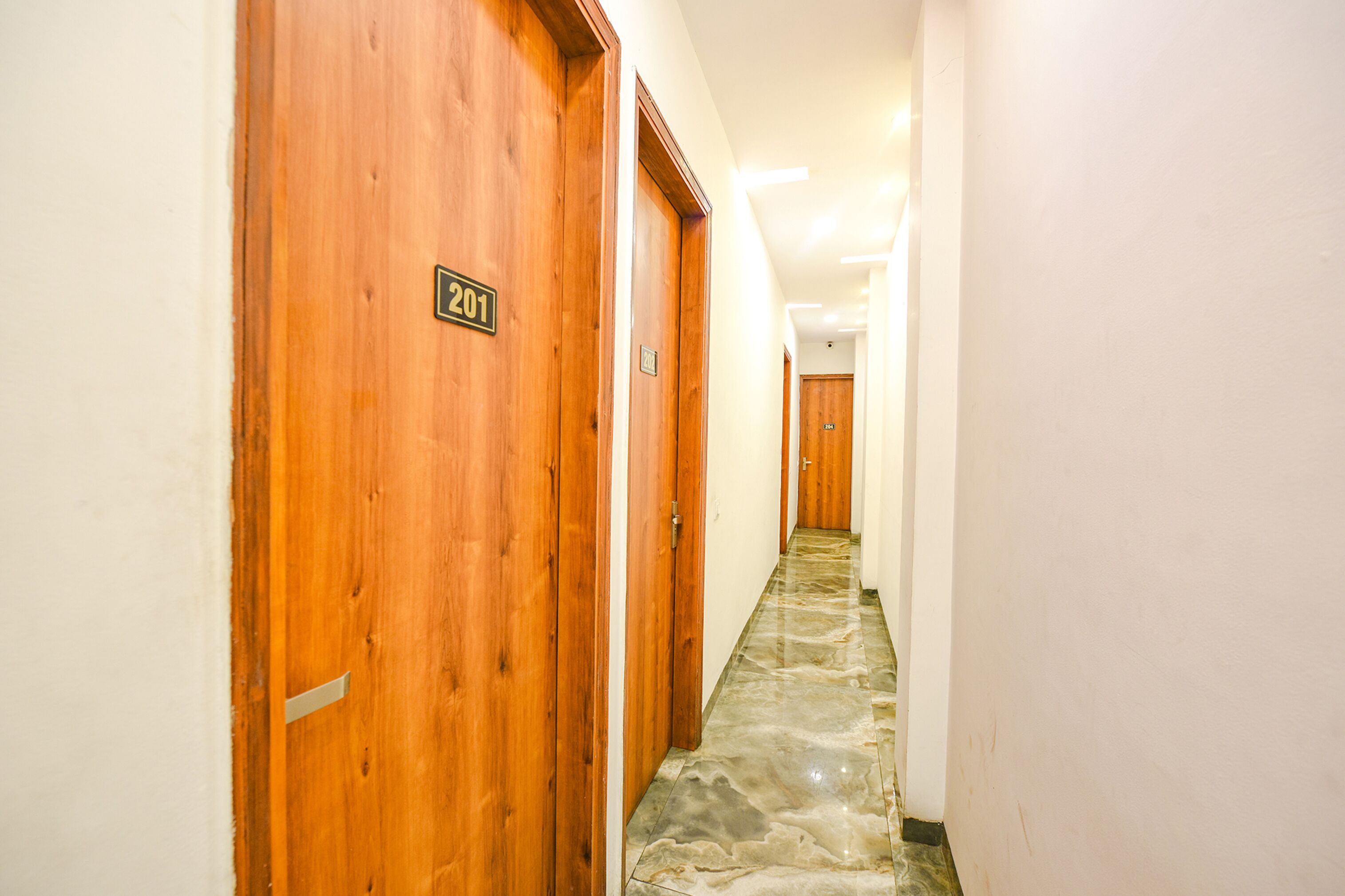 A hallway with wooden doors, each marked with a number.