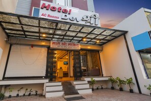 A hotel with a signboard for AC rooms and a name in a local language. - FabHotel Devs Inn (Indore)