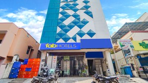 A tall building with a blue and white facade, labeled "fabHOTELS". - Fabexpress Silver Palace (Chennai)