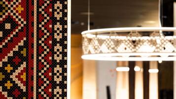 A patterned wall and a modern chandelier.