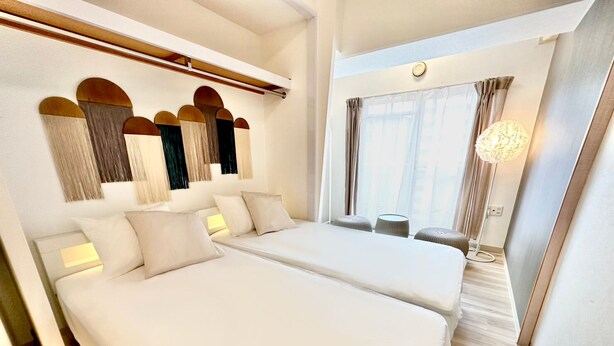 A hotel room with two beds, a small seating area, and a large window with curtains. - 8Greige ] 2min Dotonbori Namba Kuromon Wi-Fi 〇 (Osaka)