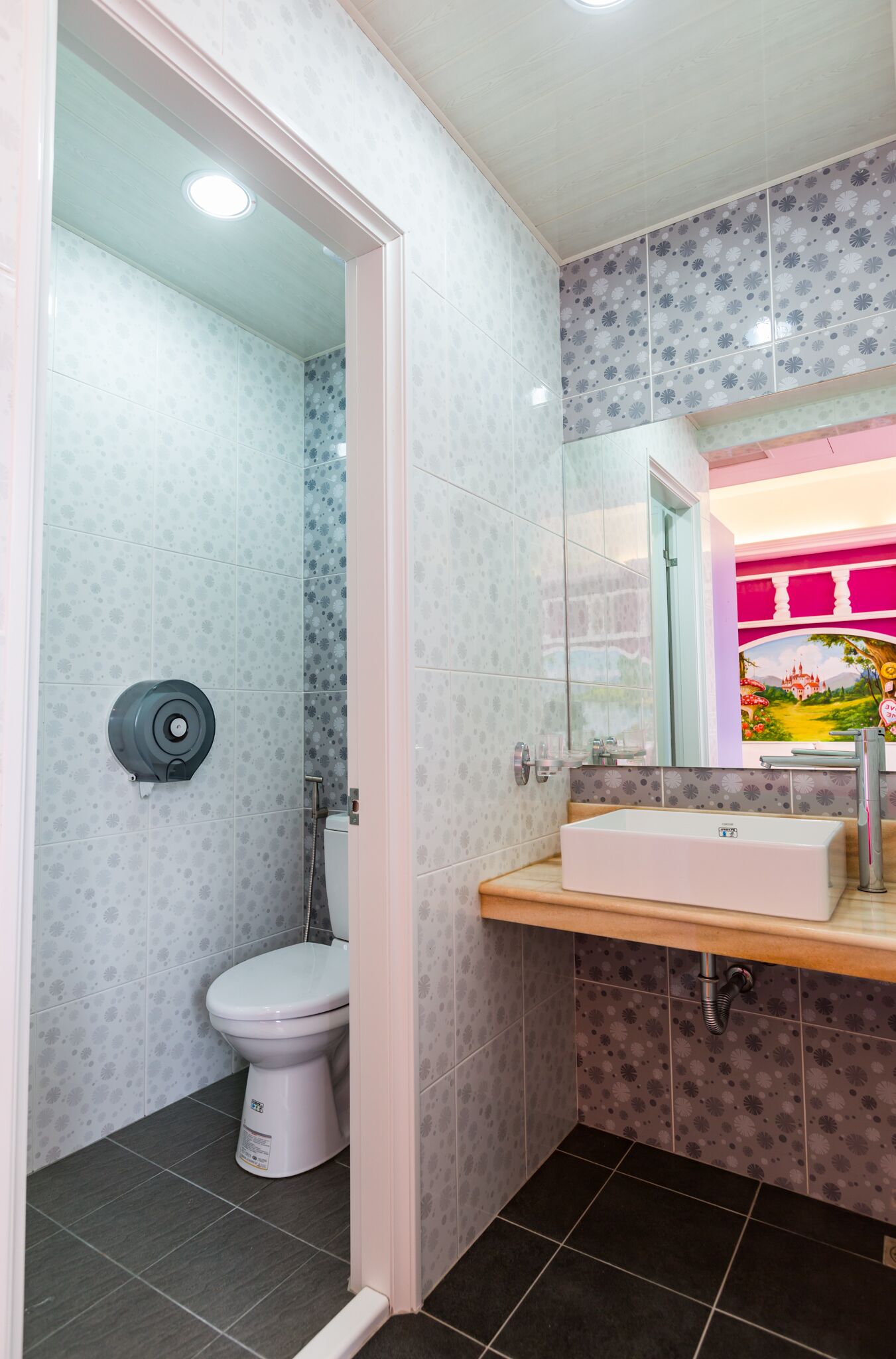 A bathroom with a toilet, a sink, and a shower.