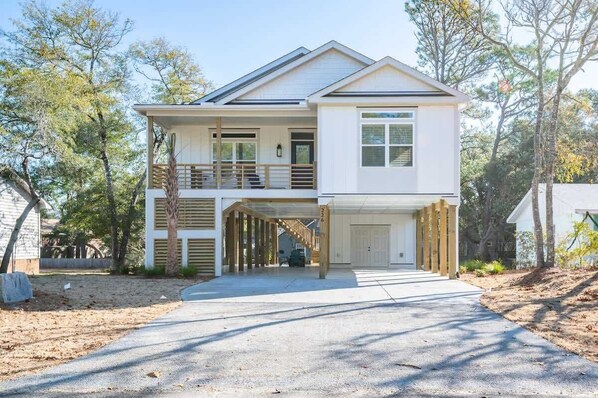 A two-story house with a covered front porch and a garage.