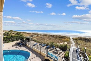 A pool area with a view of the beach and ocean. - Oceanfront Summit Bliss 3 BR w/ balcony (North Myrtle Beach)
