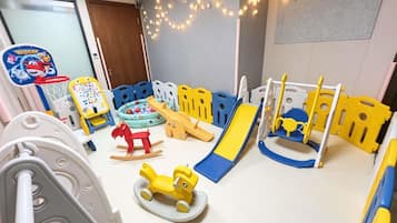 A children's play area with various toys and play structures.