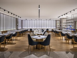 A modern conference room with a long table, multiple chairs, and a large window. - Novotel Shanghai Jingan (Shanghai)
