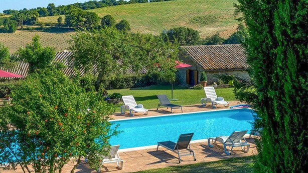 A swimming pool with lounge chairs, a stone building, and a grassy area with trees. - Luxurious home in Bagnoregio (Bagnoregio)