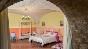 A bedroom with a bed, a chair, a small table, and a shelf. - Luxurious home in Bagnoregio (Bagnoregio)