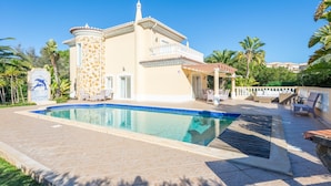A pool area with a pool, lounge chairs, and a building with a balcony. - Lote 50 at Boavista Resort Lagos (Lagos)