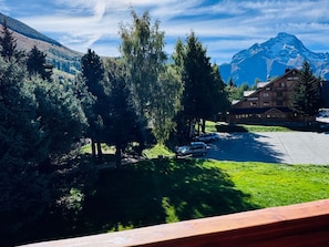 A mountain lodge with a restaurant and bar, surrounded by trees and a view of a mountain.