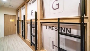 A hallway with multiple rooms labeled TIMES INN, each with a distinct letter on the wall. - Times Inn - Tainan  (Tainan)