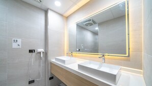 A modern bathroom with two sinks, a large mirror, and a shower area. - Times Inn - Tainan  (Tainan)