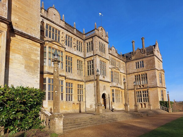 A large, historic building with multiple windows and a central entrance.