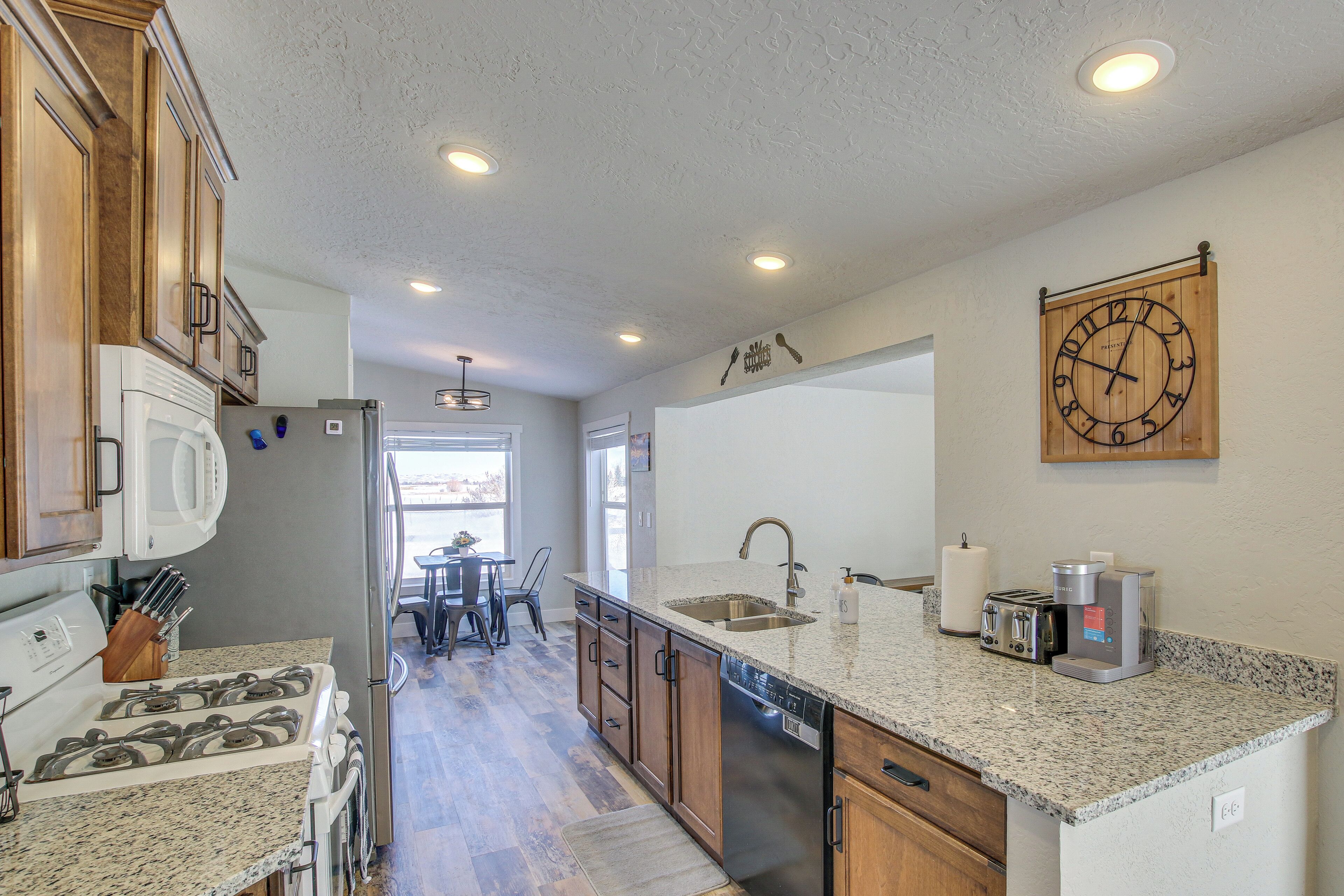 A kitchen with granite countertops, stainless steel appliances, and wooden cabinets.