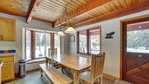 A wooden dining table with benches, large windows, and a wooden ceiling. - Peaceful Donnelly Retreat < 1 Mi to Lake Cascade! (Donnelly)