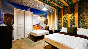 A bedroom with two beds, a mural on the wall, and a ceiling with wooden beams and greenery.