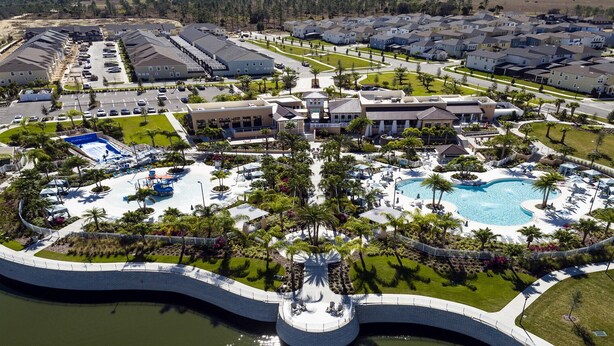 An aerial view of a resort with a central pool, multiple buildings, and a parking area. - Last Minute Disney! Private Pool, Hot Tub & Themed Bedrooms. Book Now! #91755 (Orlando)