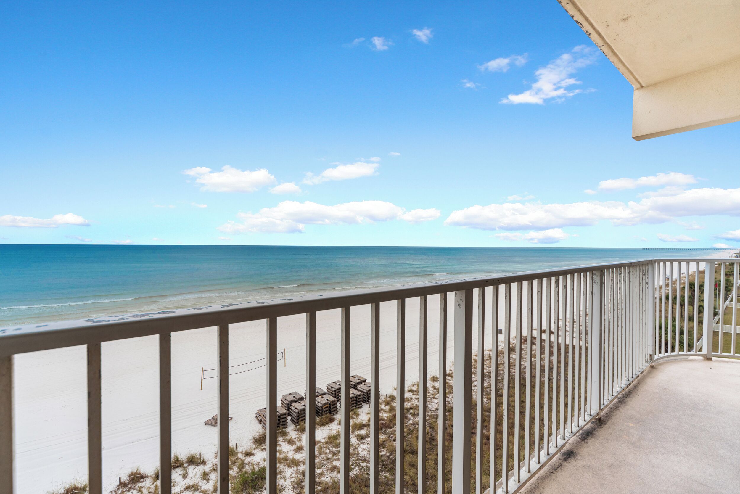 Een balkon met uitzicht op het strand en de oceaan.